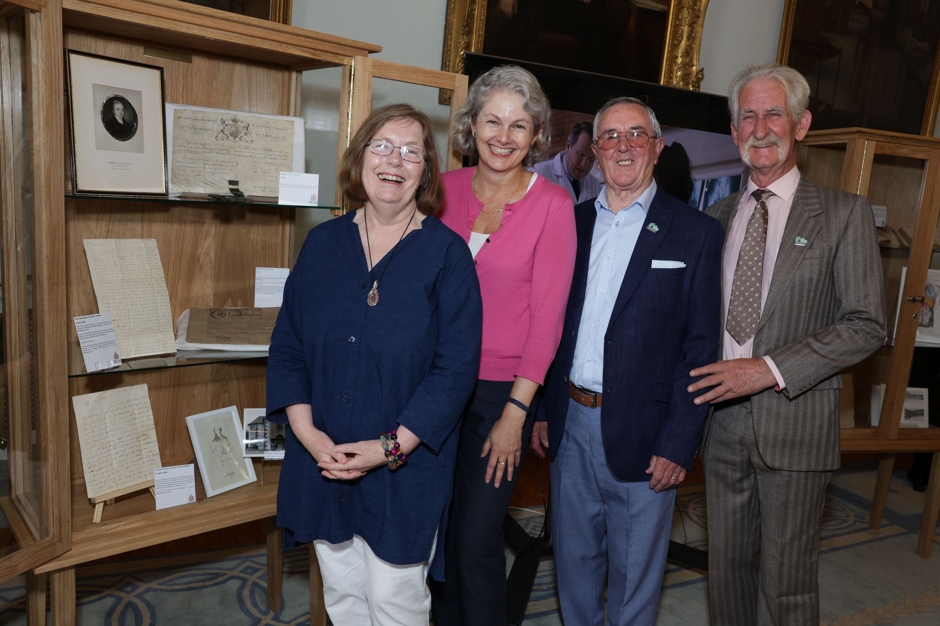 Kate Kelly and Liz Hughes (RCSI) with members of Clondalkin Men's Shed at the Colles at 250 exhibition.