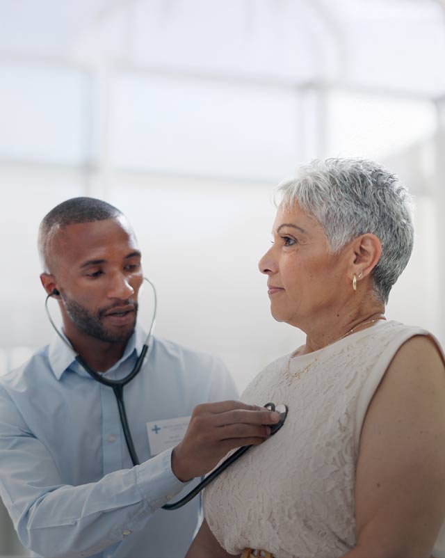 Stethoscope examination with doctor and senior woman at hospital for lungs, chest or breathing assessment