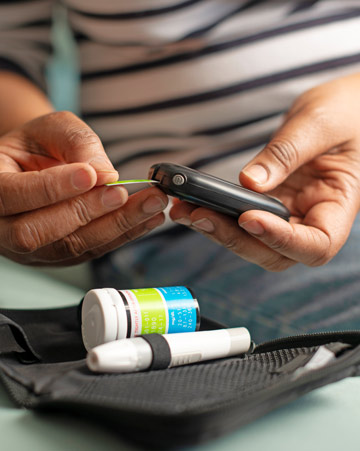 A person with diabetes uses medical paraphernalia