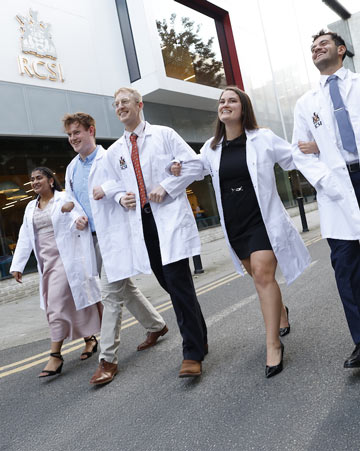 Happy students in white coats