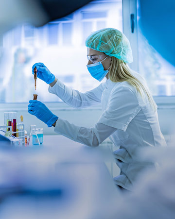 Chemist working with poisonous liquid in a laboratory.