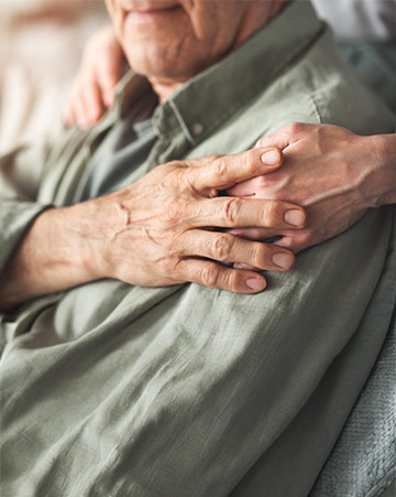 Comforting hand supporting elderly person