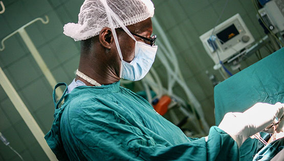 African doctor performing surgery