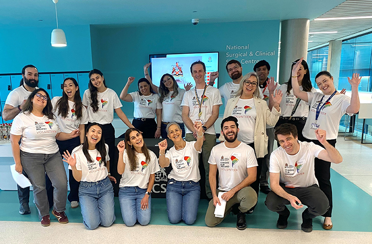 A large group of smiling staff and students, all wearing the same Chagas Hub Ireland Tshirt, pose in 26 York Street.