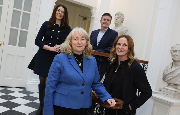 Four academics pose in the Atrium of 123 St Stephen's Green