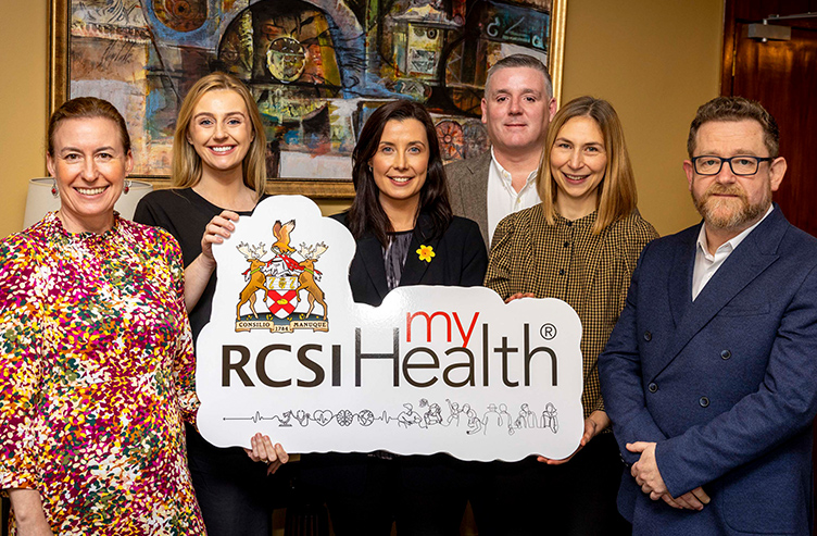 A group of people hold up a sign that reads 'RCSI MyHealth'