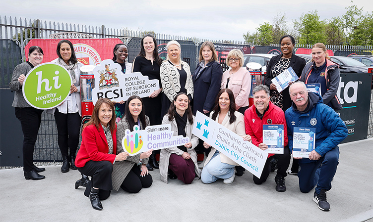 A group of people pose with various signs, including RCSI, Healthy Ireland, Dublin City Council and Slaintecare as part of the Uisce Cliste launch event.