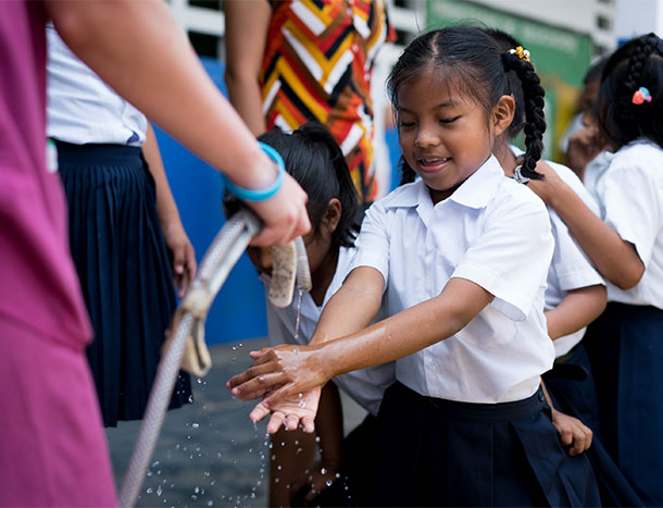 Girl getting water from hose