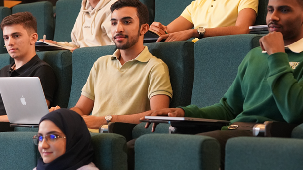 A group of young people sitting in a lecture hall
