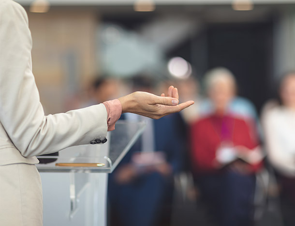 Stock photo of a speaker at a conference