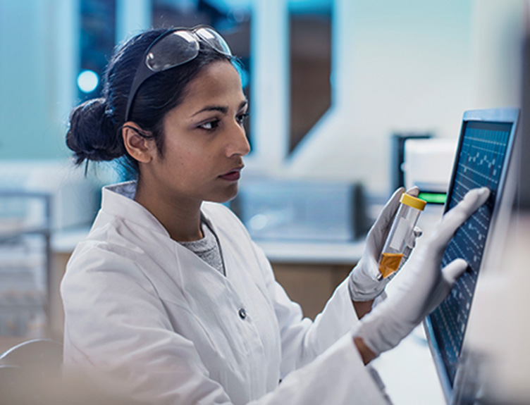 Woman in lab with sample and screen