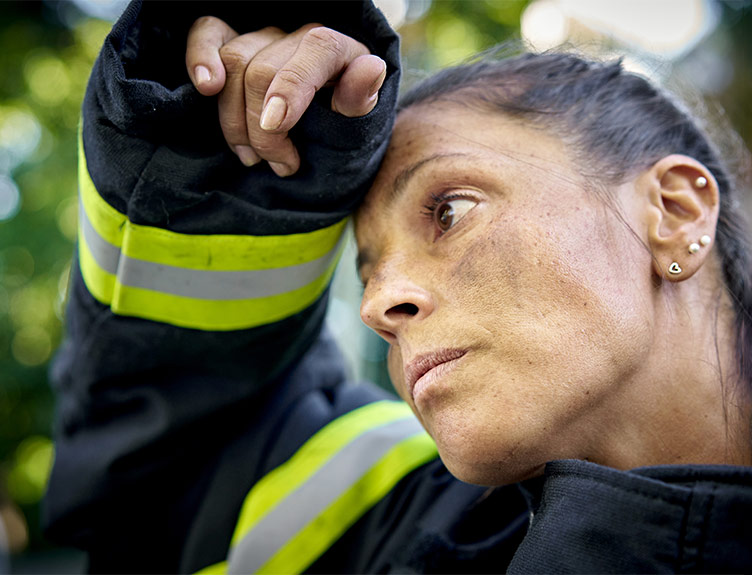 Firefighter with hand on head