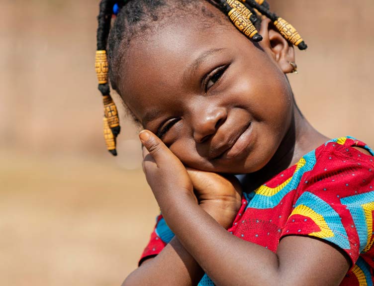 Close-up image of smiling African child in colourful clothing