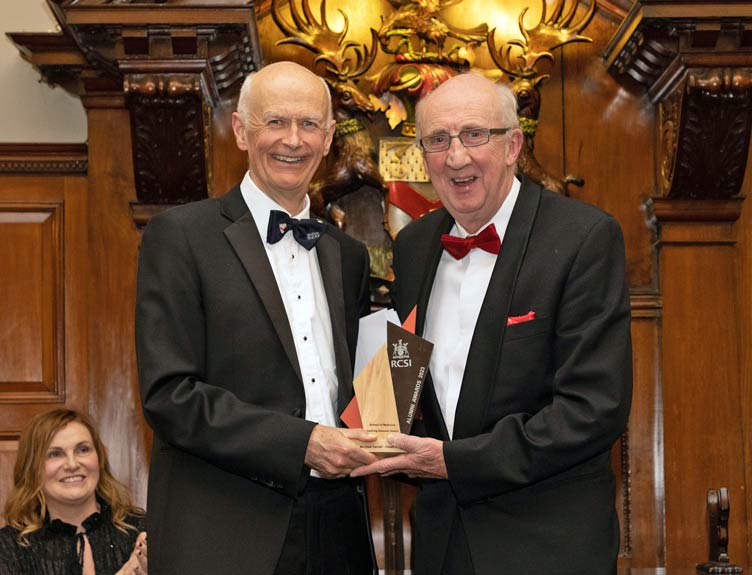 A man is presented with an award at a ceremony