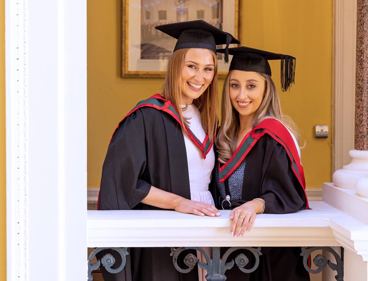 Two graduates pose for a photo at RCSI