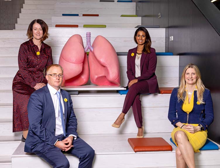 Lung Cancer Partnership Group shot with four people sitting on steps