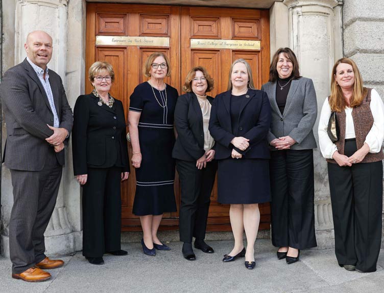 RCSI Human Trafficking Summit Seven individuals pose outside a historic building