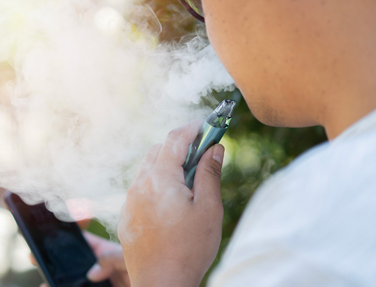 research about health effects A vape user with smartphone