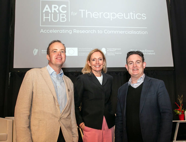 Three people pose in front of screen with ARC Hub branding