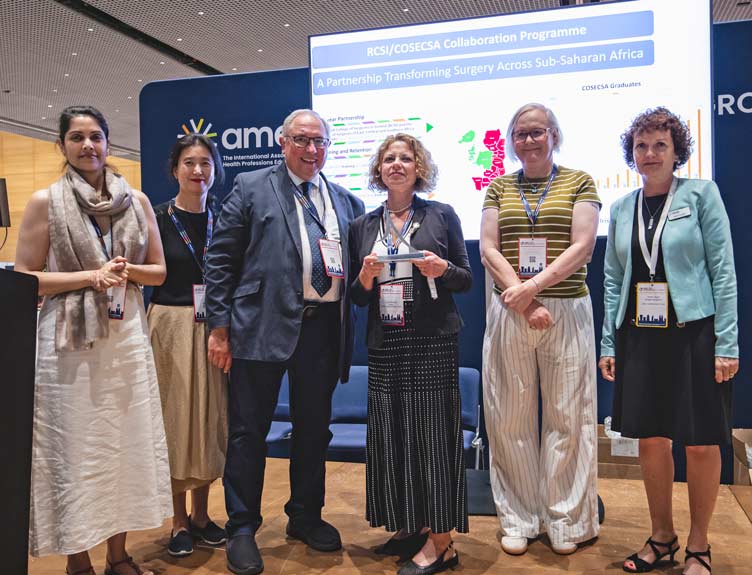 Aspire Award Group of six people pose with award trophy