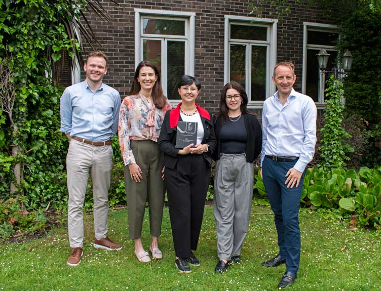 Group poses with award