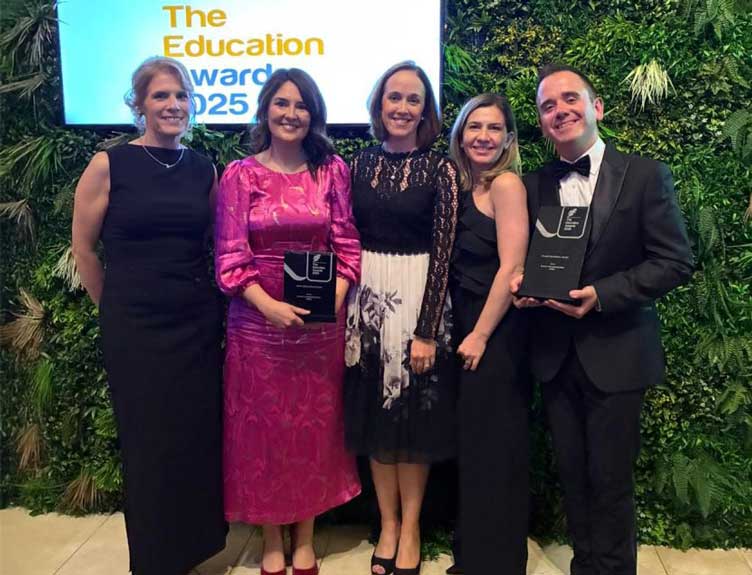Group poses with award at event