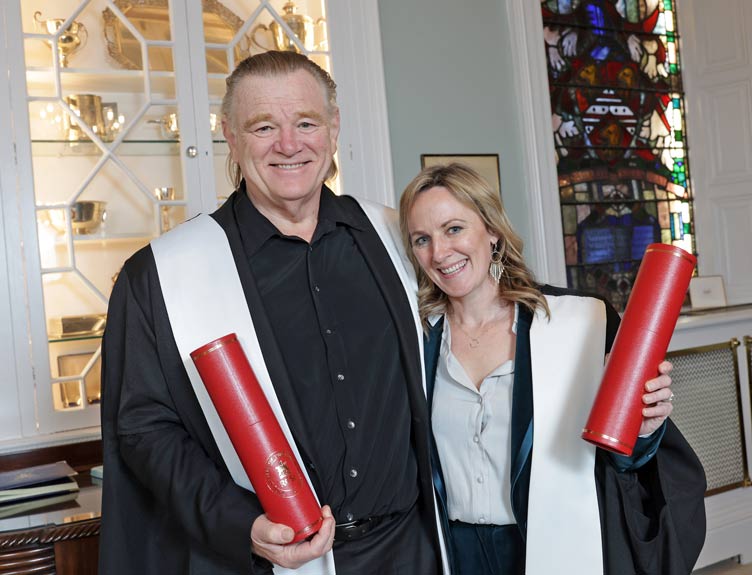 Two honourees display their Fellowships