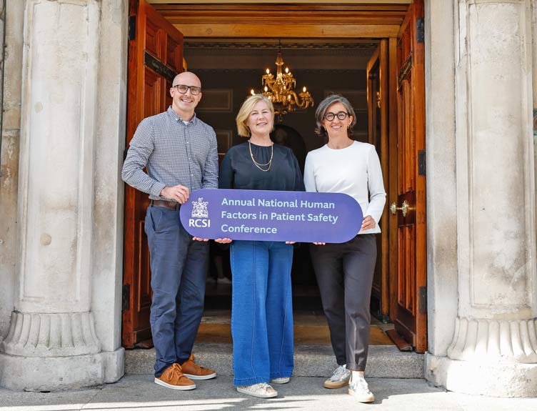 Human Factors conference Three people hold up signage to promote RCSI's Human Factors conference