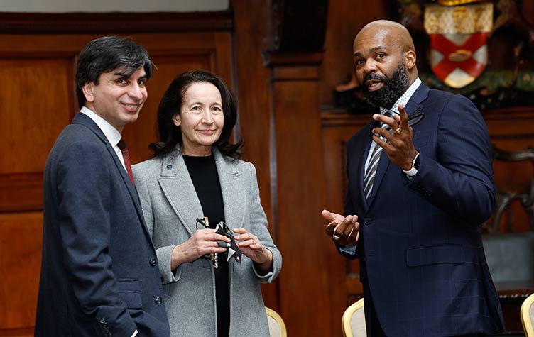Three smiling symposium attendees