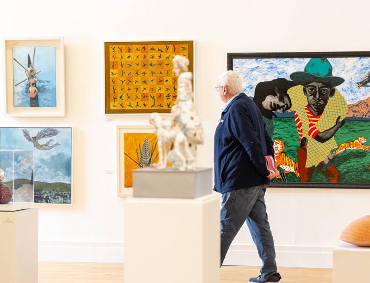 RHA exhibition Man walks through art exhibition