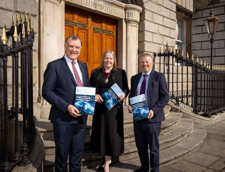 Three surgical professionals hold the AI and Digital Surgery report outside 123 St Stephen's Green