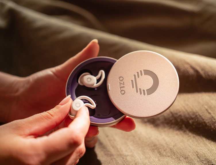 Close-up of hands holding Ozlo Sleepbuds