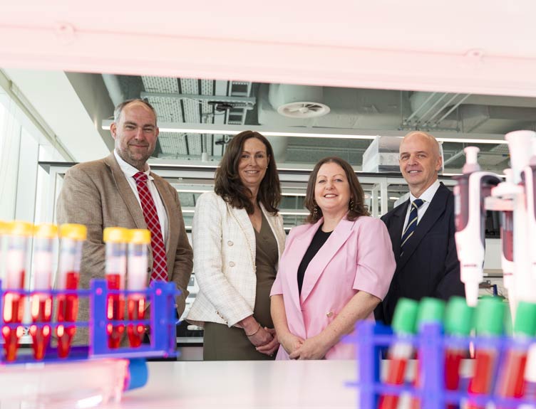 Professor James O’Donnell with three colleague pictured with test tubes in foreground