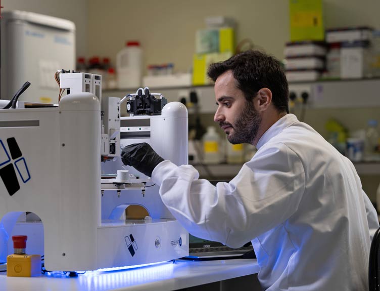Researcher in lab wearing white coat