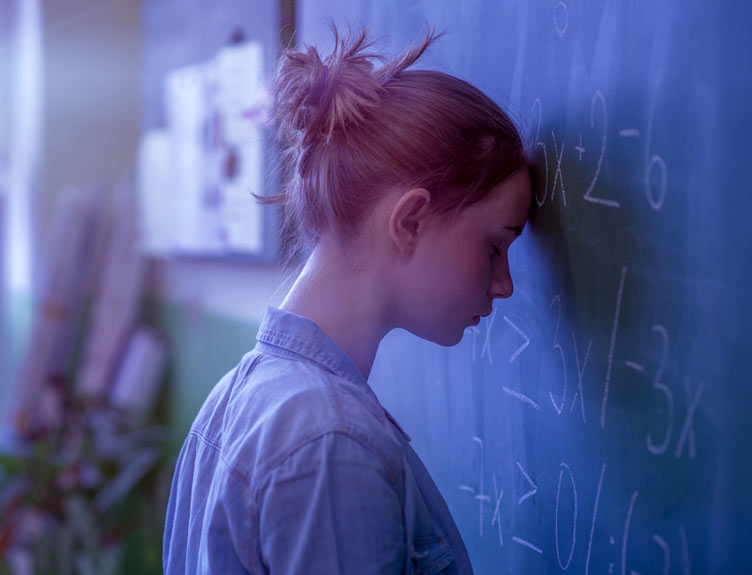 Upset teenager against wall