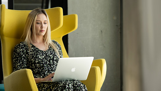 Female RCSI employee on laptop in ERC Beaumont