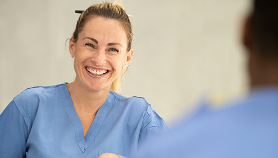 Male and female in scrubs talking in ERC Beaumont