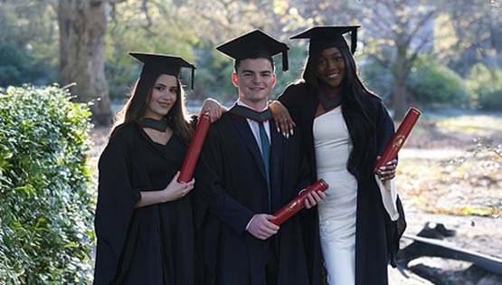 Med graduates pictured in St Stephen's Green wearing conferring caps and gowns