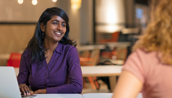 Student converses in university setting