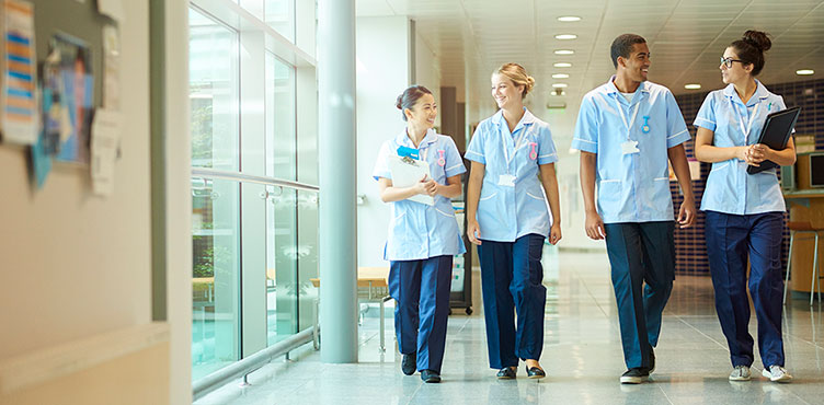 Four nurses walking in hospital