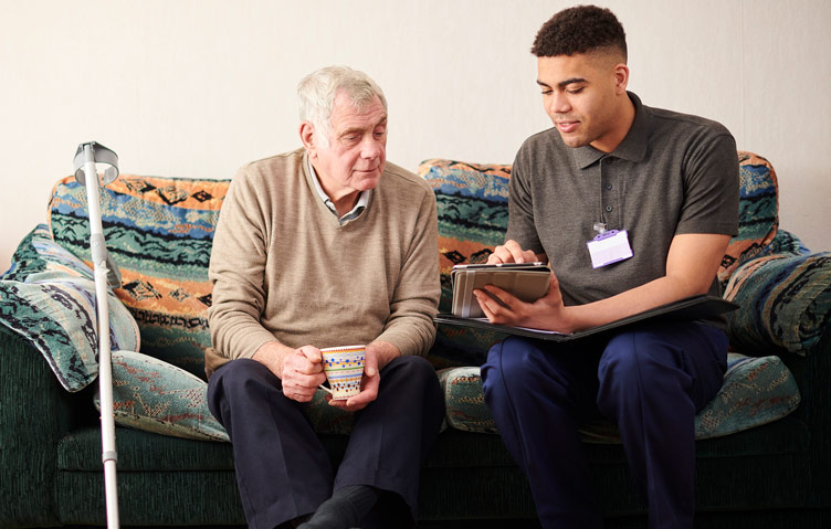 Nurse helping elderly man