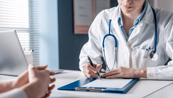 Doctor writing on a notepad