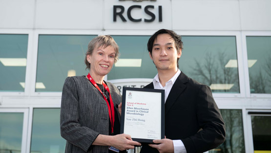 Winner of the Ellen Moorhouse Prize 2025 receiving their award in front of building with RCSI logo