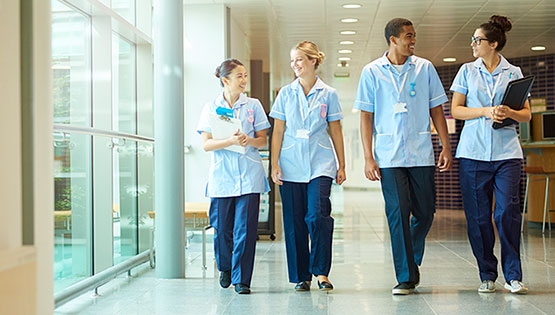Four medical professionals walking