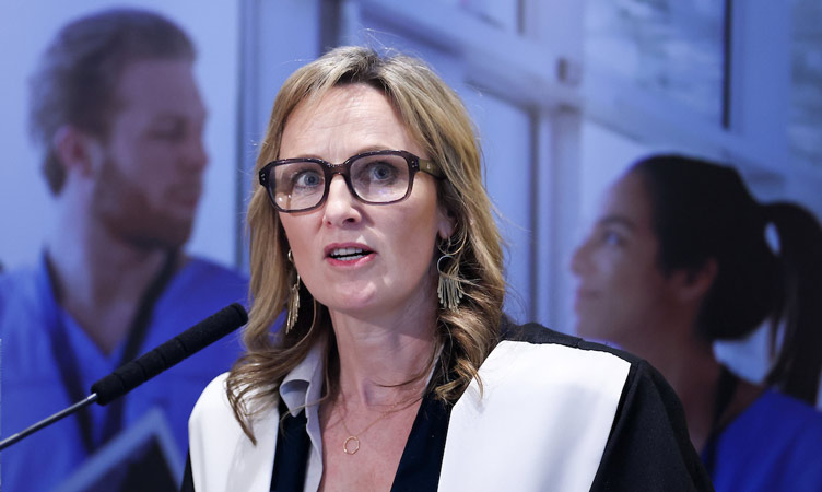 Speaker wearing glasses at a conference