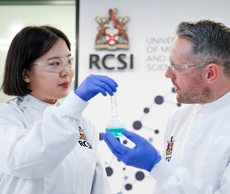 Pharmacy student interacts with lecturer in university setting