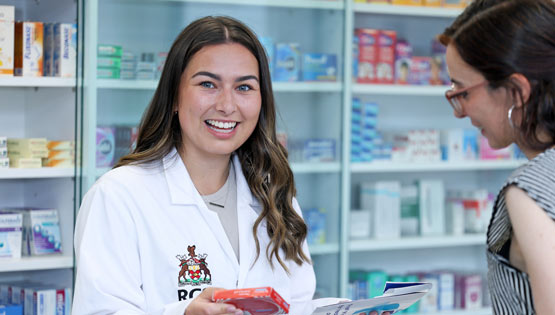 Pharmacy student in white coat in university setting