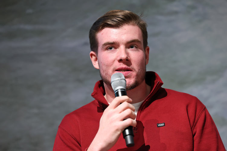 Student holds microphone during speech