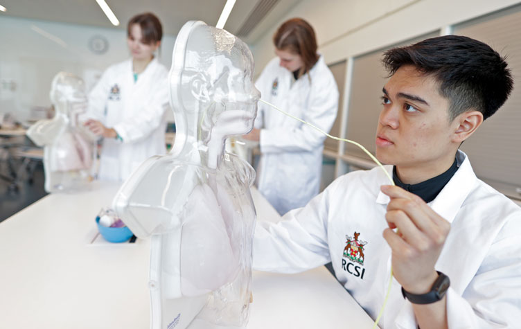 Students in white coats in learning environment