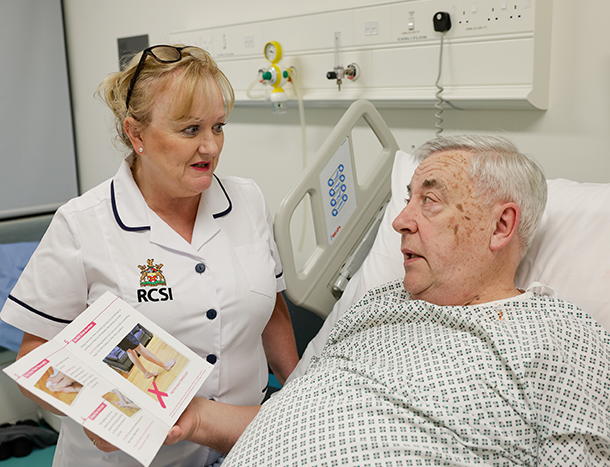 A nurse discusses post-op care with a senior patient